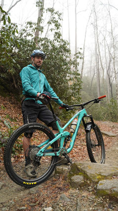 richie trent standing next to his mountain bike